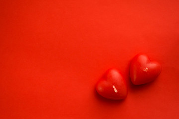 Valentines day background with red hearts on red table, top view.