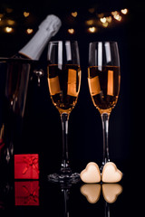 Two wine glasses, gift in a box and two heart-shaped chocolates