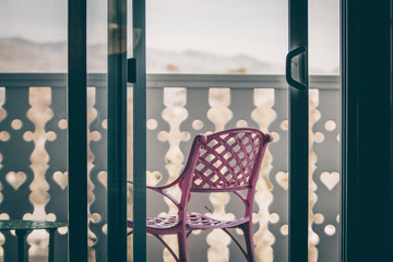 empty pink chair on balcony