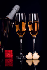 Champagne bottle, two wine glasses and chocolates heart
