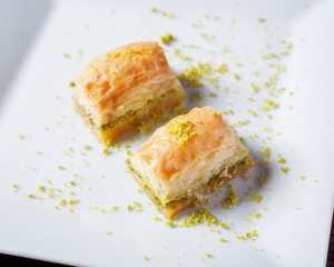 Sweet Turkish dessert, baklava - Close up of baklawa beautifully arranged on a white plate