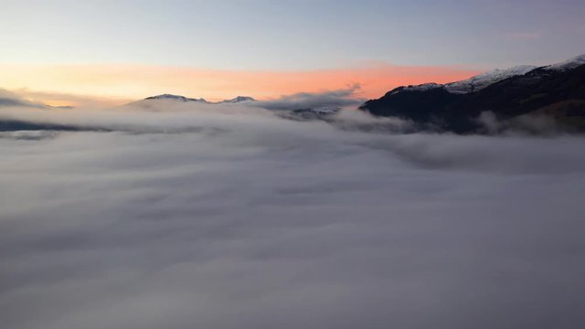 Drone flying over clouds. Sunset Timelapse.