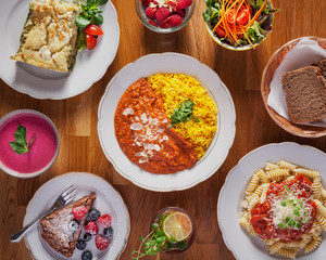 Mixed dishes for summer, curry - Fresh vegetarian meals, beautifully arranged on a wooden table