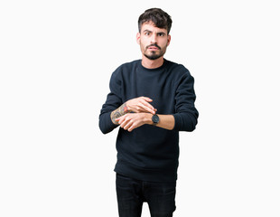 Young handsome man over isolated background In hurry pointing to watch time, impatience, upset and angry for deadline delay