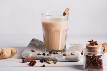 Masala chai tea on the white background. Hot indian beverage with spices