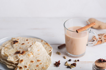 Masala chai and paan bread tea on the white background. Hot indian beverage with spices