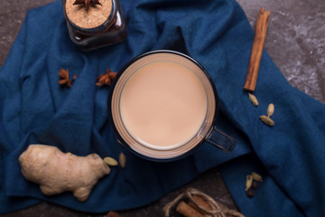 Masala chai tea on the dark background. Hot indian beverage with spices