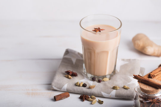Masala chai tea on the white background. Hot indian beverage with spices. Horizontal orientation