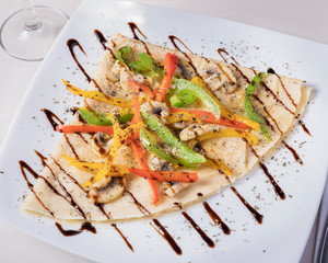 spicy desert, humus crepe - Delicious crepe served on a white plate on a white table