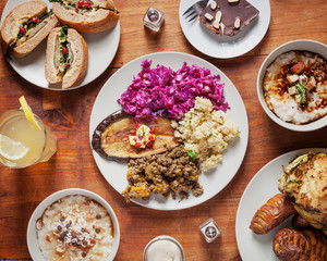 Top view of mixed vegan food - Oven baked vegetables arranged and served on a wooden table