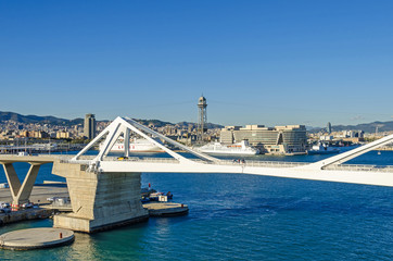  Port Vell with its bridge Porta d'Europa and the aerial tramway tower Torre Jaume I in Barcelona