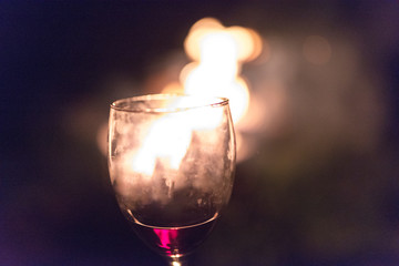 wine glass in front of a fire
