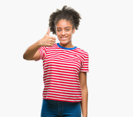 Fototapeta na wymiar Young afro american woman over isolated background doing happy thumbs up gesture with hand. Approving expression looking at the camera with showing success.