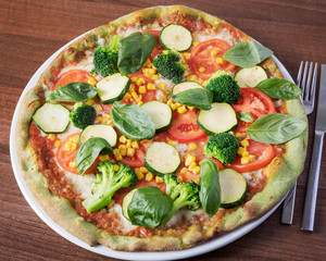 Italian Pizza, Verdura - Delicious vegetarian Pizza, beautifully arranged on a wooden table