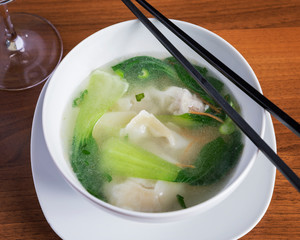 Chinese food, Wantan soup - Top down view of delicious oriental dish, beautifully arranged on a wooden table