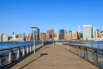 Naklejka premium Pier in New York City - USA. Manhattan downtown skyline in the morning al view of New York City - USA. Manhattan downtown skyline and skyscrapers.