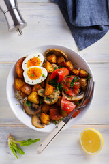 Smoked salmon breakfast bowl with egg, potatoes, mushrooms and rice. View from above, top studio shot