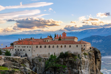 Fototapeta na wymiar Agios Stephanos or Saint Stephen monastery located on the huge rock with mountains and town landscape in the background, Meteors, Trikala, Thessaly, Greece