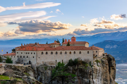 Agios Stephanos or Saint Stephen monastery located on the huge rock with mountains and town landscape in the background, Meteors, Trikala, Thessaly, Greece © vadim.nefedov