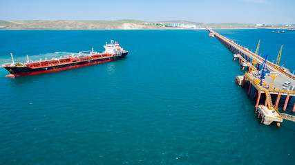 tanker moored to the port using tugs