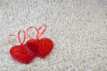 Red glass hearts on a carpet love and Valentine concept. Copy space.         