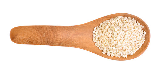 Sesame seeds on a wooden spoon as a white background.