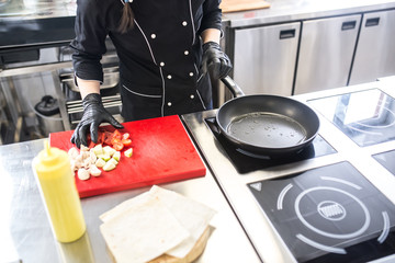 Working process of cooking vegetables on a frying pan