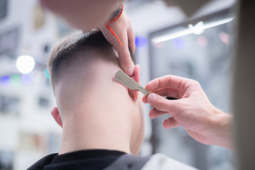 The process of male haircut in barbershop. Guidance circuit beard and hairstyle.