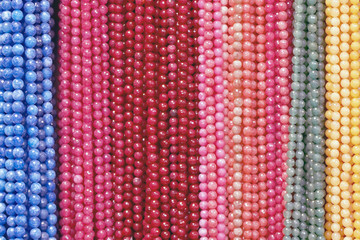 Colorful Beads Background. Background pattern of multicolored natural stone beads. String of beads in various colors. Colorful beads necklaces. Handicraft fashionable for women