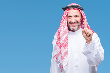 Senior arab man wearing keffiyeh over isolated background showing and pointing up with finger...