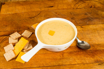 Bowl of Broccoli and Cheese Soup on Rustic Table