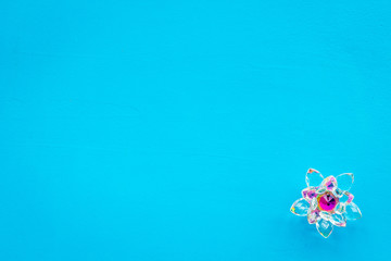 Buddhist symbol. Lotus flower on blue background top view copy space