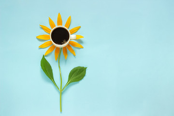 Cup of black coffee and yellow petals stalk flower shaped. Creative Flat lay Top view Copy space. Concept good morning