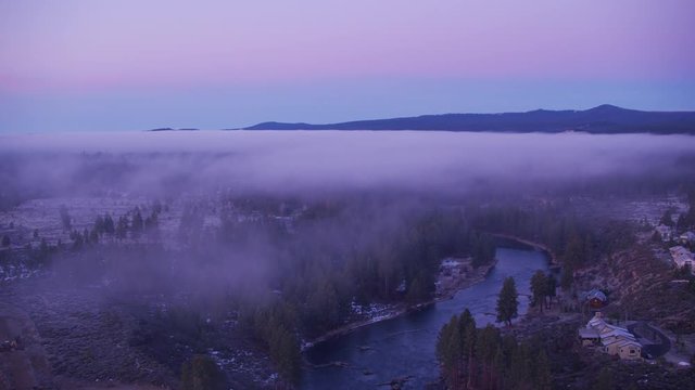 Oregon circa-2018. Flying over Deschutes river with low fog just outside of Bend, Oregon. Shot from helicopter with Cineflex gimbal and RED Epic-W camera.