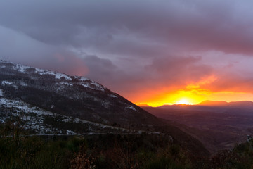 Mountain Landscape at Sunset on Cloudy Sky Background