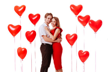 Kissing couple posing on white background with balloons heart. Valentine's day.