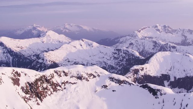 British Columbia, Canada circa-2018. Aerial view of snow covered mountain range.  Shot from helicopter with Cineflex gimbal and RED Epic-W camera.