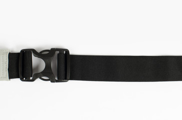Buckle from plastic with black belt on the white background