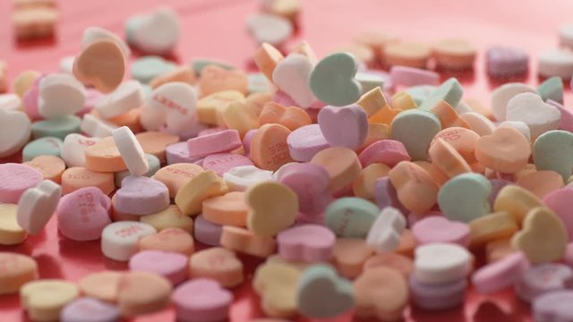 Valentine's Day heart shaped candy falling and bouncing in slow motion. Shot on Phantom Flex 4K.