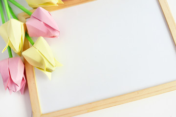tulips of origami on a white background, a wooden frame