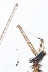 Construction cranes at work to construct a tall building in Bangkok