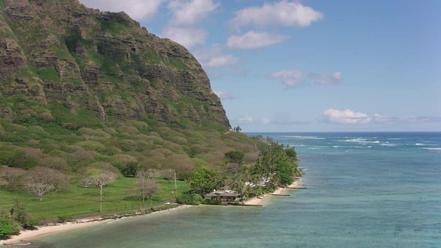 Oahu, Hawaii circa-2018.  Aerial view of beautiful coast line at Kaaawa Valley.  Shot with Cineflex and RED Epic-W Helium. 
