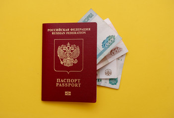 Passport and money on the yellow background flat lay
