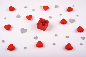 Red gift box on white background many red and silver hearts. Valentines Day