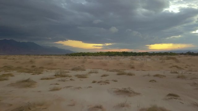 Flying over Edom Mountains Arava Rocky Desert. Israel Aerial Drone Of Middle Eastern Desert Convoy Tourism.Sand sandy desert and clouds. kibbutz in southern Israel