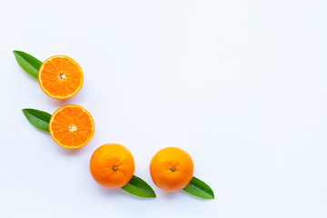 High vitamin C,  Fresh orange citrus fruit with green leaves on white background.