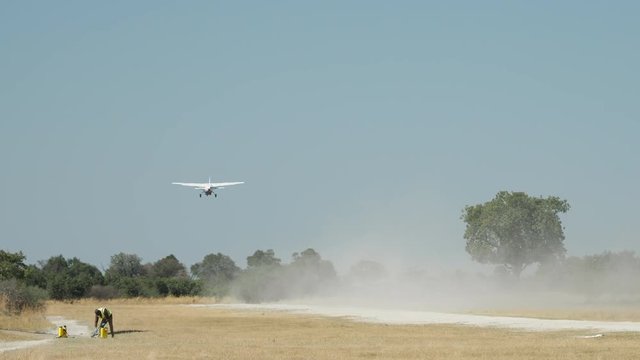 Airplane taking off from dirt runway in Botswana Africa
