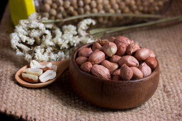 Peanut on Cup made of wood and spoon 
