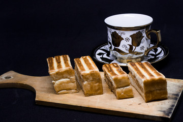 toast with chocolate sprinkles and tea to accompany relaxing time with a black background