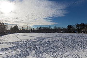 Soccer field in winter after the snowstorm past. Winter activity on the soccer field covered by snow.